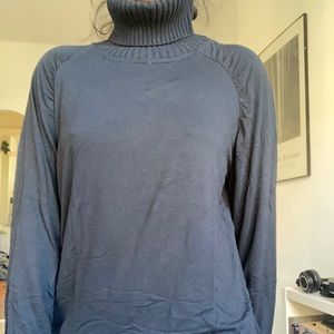 Black turtleneck with knit ribbed neck and soft flowy body